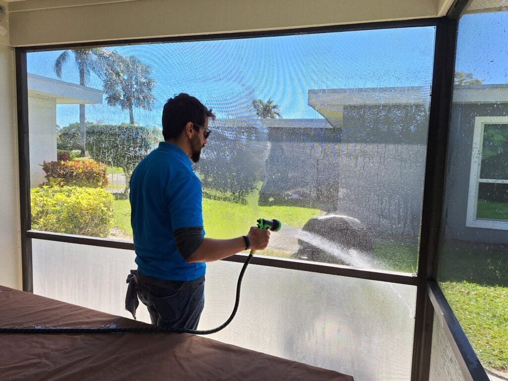Man cleaning Screen Enclosure in Palm Beach Gardens FL