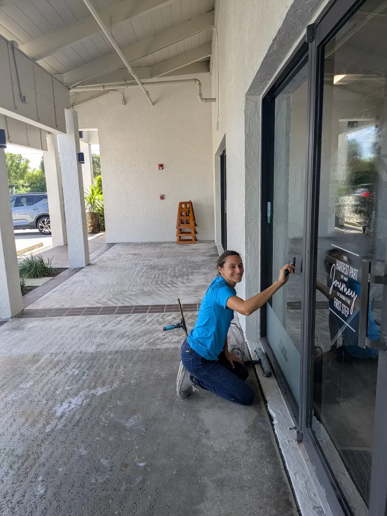 Window washer cleaning a storefront window